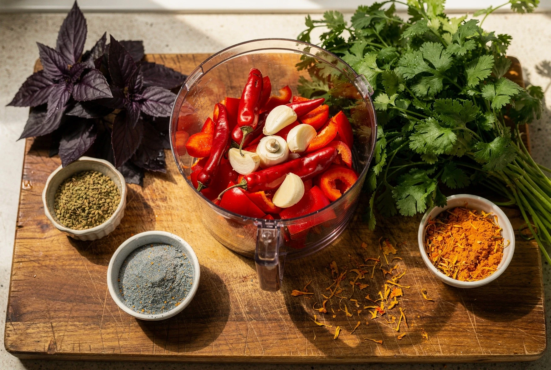 Chopped red peppers, chilies, garlic, and fresh herbs ready for making adjika