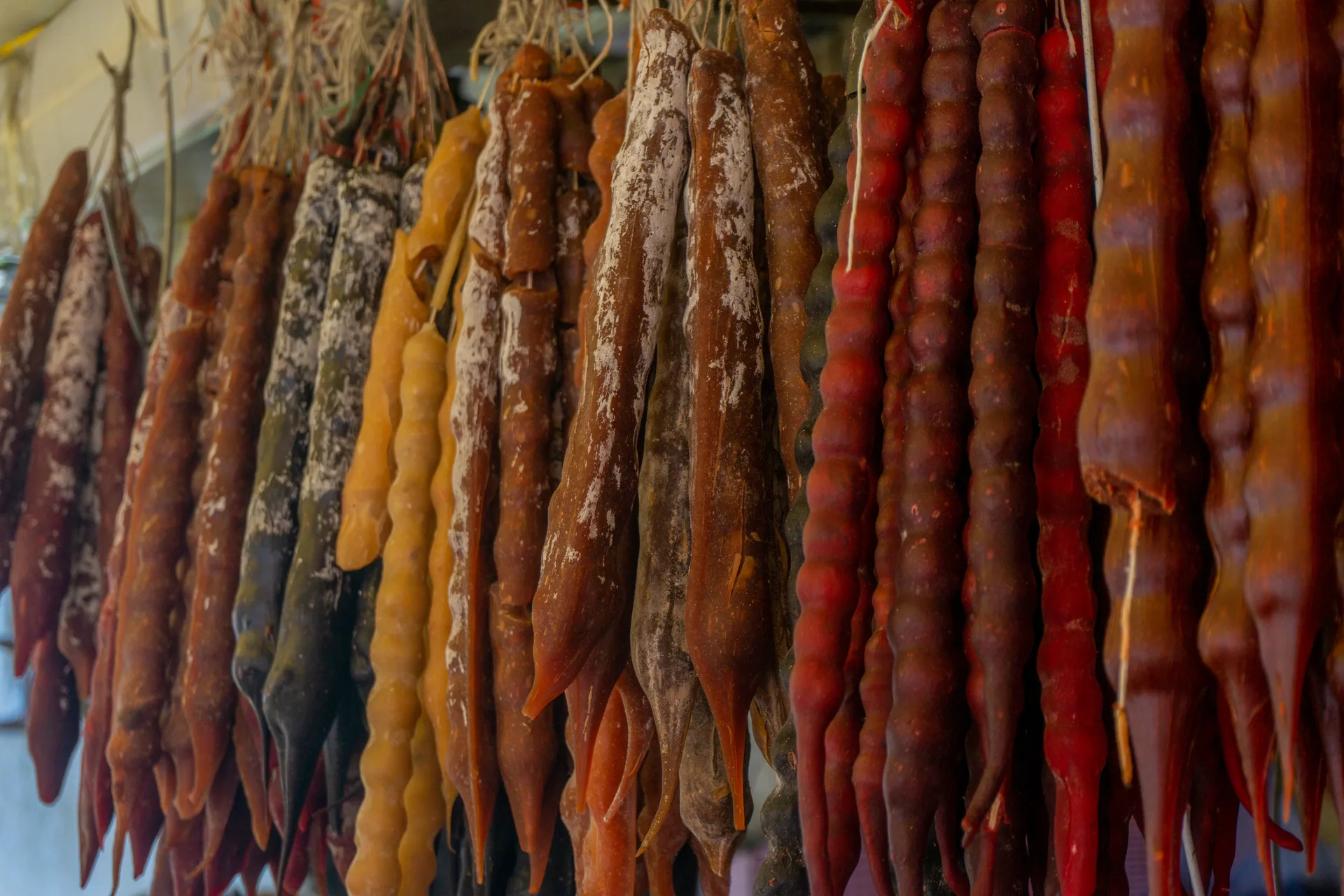 Churchkhela strings in various colors hanging to dry at a Georgian market