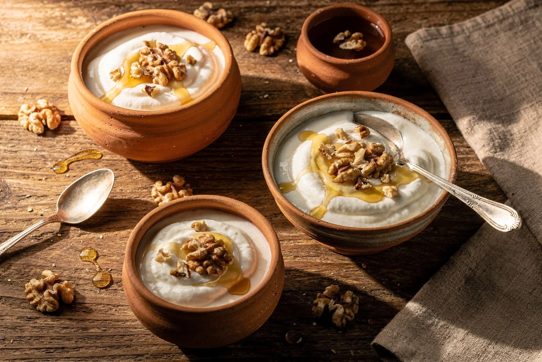 Homemade matsoni served with honey and walnuts on a Georgian breakfast table