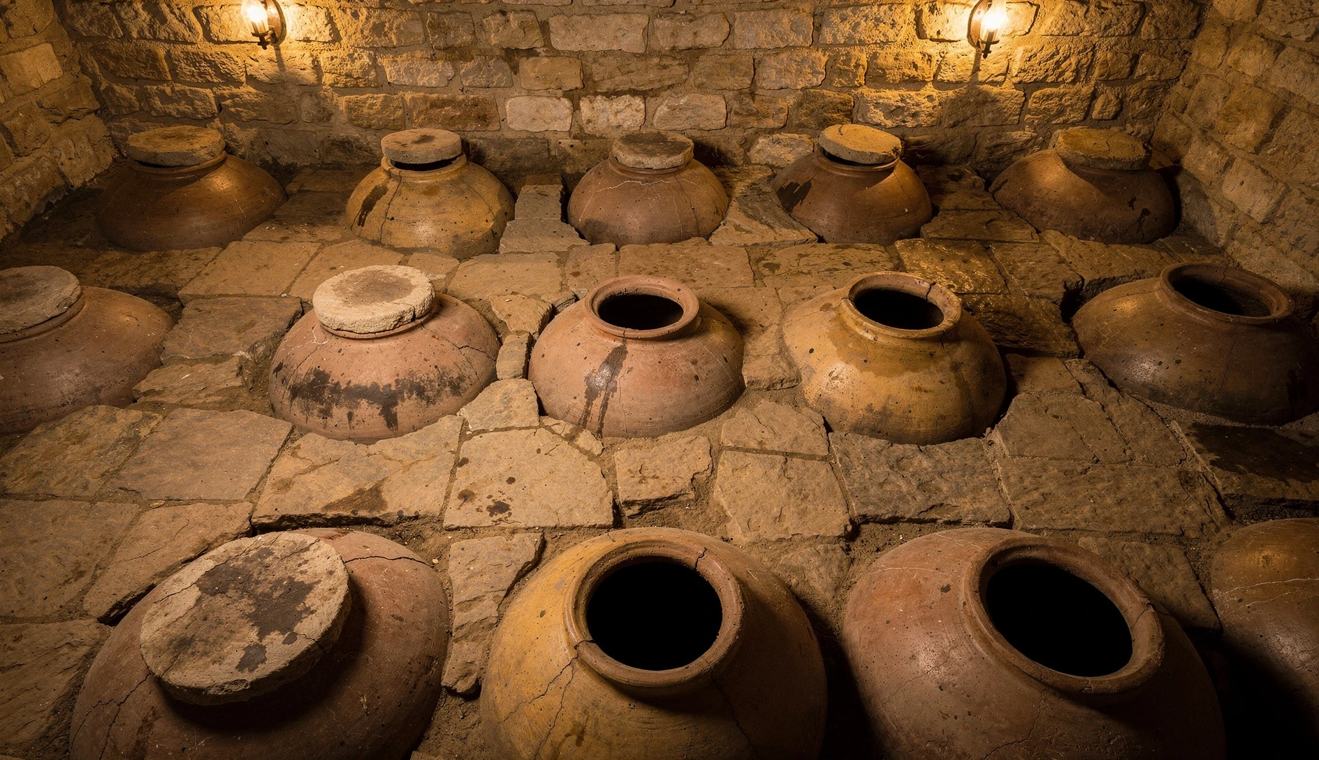 Traditional Georgian marani wine cellar with clay qvevri vessels embedded in the stone floor
