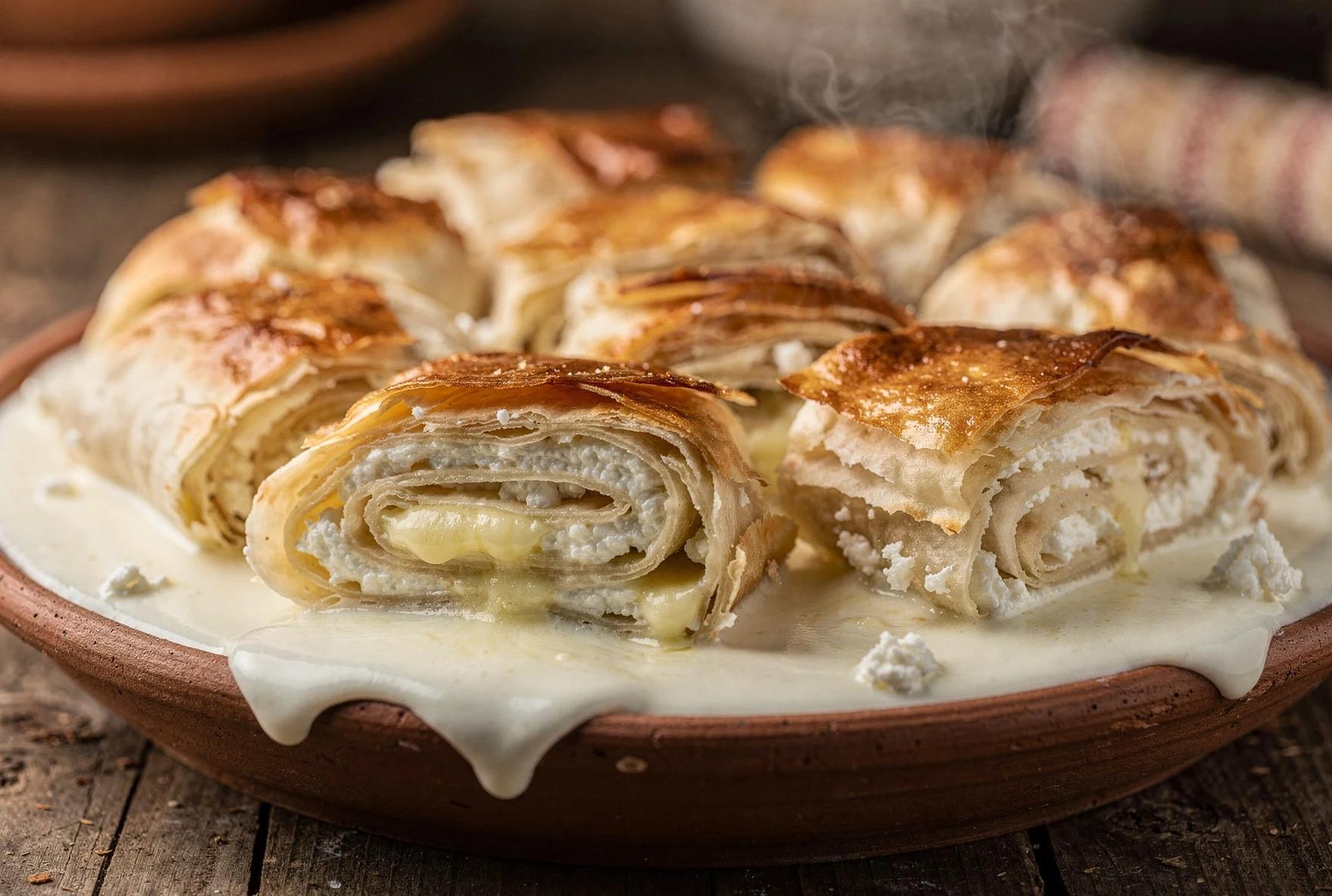 Close-up of sinori rolls showing the spiral cross-section of lavash with melted butter and cheese between layers